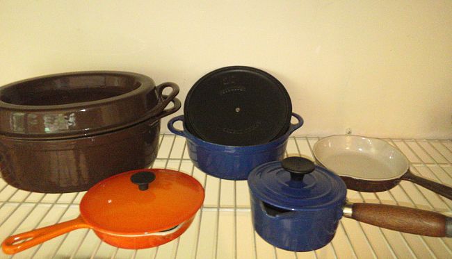 Modern cast iron cookware is probably the easiest to clean as the base is black anyway. But good quality items are extremely expensive and the pots and pans are very heavy.