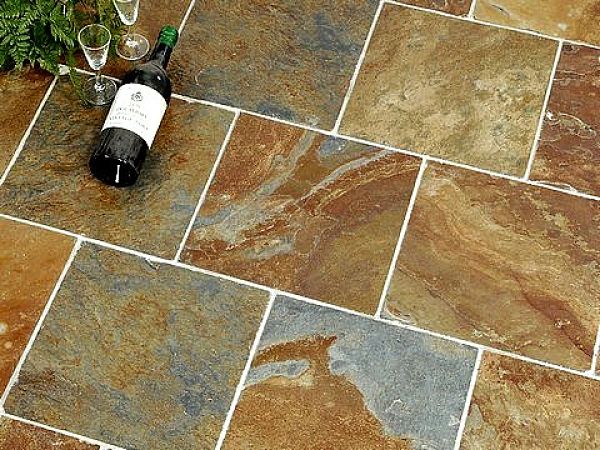 Slate tiles are vulnerable to staining through wine spills and other acid foods and drinks. They can be very hard to clean. Learn the secrets here.